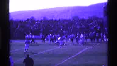 Ohio USA (1969): As A Football Game Is Happening A Car Is Being Backed Up And A