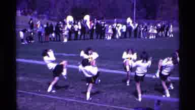 Ohio USA (1969): Cheerleaders Dressed In White Perform Cheer On Field On A Bright