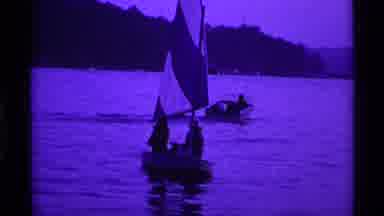 Ohio USA (1969): Small Sailboat Sailing Through The Water In The Evening Near A