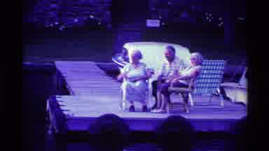 Ohio USA (1969): Three Elderly People Sit In Chairs On A Wooden Dock And Watch