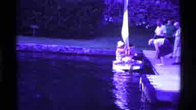 Ohio USA (1969): People Lower Sail On Sailboat While At Dock On Lake In Clear