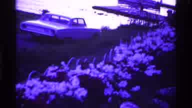 Ohio USA (1969): Old Car Stopped Next To A Flower Bed On A Beautiful Sunny Day