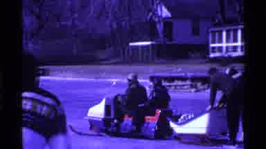 Ohio USA (1969): A Group Of People Being Pulled By A Snowmobile On Ice While A Man
