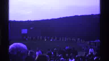 Ohio USA (1969): Line Of People In Raincoats Walking With Crowd In Background With