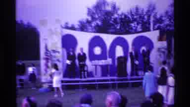 Ohio USA (1969): A Formal Gathering Outside With People Sited On A Stage