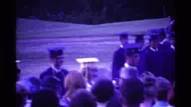 Ohio USA (1969): Graduates In Cap And Gown Stand In Formation While Some March