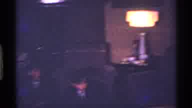 Ohio USA (1969): Woman Wearing Black Dress Sits Next To Fully Trimmed Christmas