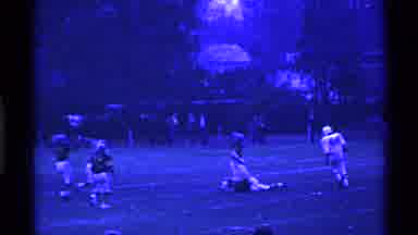 Ohio USA (1969): Football Player Falls On The Football Field And Team Players Rush