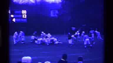 Ohio USA (1969): High School Football Players Tackling On Court With Fans Watching