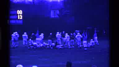 Ohio USA (1969): Football Players Play On A Field At Sunset Near A Goalpost And