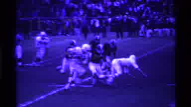 Ohio USA (1969): Football Runner Going Straight Home With Team Running After Him