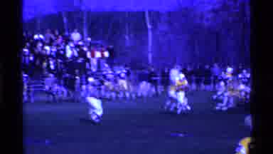 Ohio USA (1969): Two Teams Playing A Game Of Football As Spectators And Fans Watch