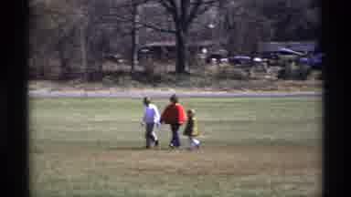 Florida Michigan (1970): Family Walks Across Open Field Of Grass During The