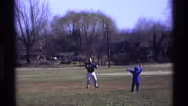 Florida Michigan (1970): Boy Wearing Blue Shirt Throws Object To Person Wearing