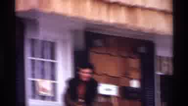 New York City (1970): A Women Standing Outside Of Her Those On A Stoop Enjoying