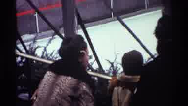 New York City (1970): Woman Wearing Brown Fur Coat Picks Up Child Wearing Tan Coat