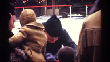 New York City (1970): Man Wearing Black Hat Talks To Boy Wearing Tan Coat And Hat
