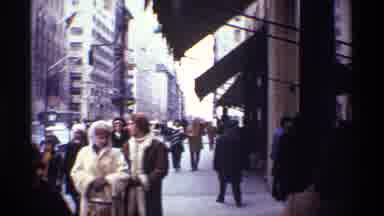 New York City (1970): People Walk On City Sidewalk And Street Wearing Coats In