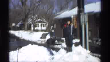 New York City (1970): Kid Wearing Grey And Black Coat Looks At Snow Pile On A