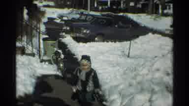 New York City (1970): Person Wearing Black Coat Stands On Top Of Snow Drift On A