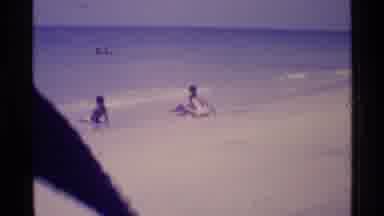 Florida USA (1973): Two People On The Beach Observing What Is In The Water