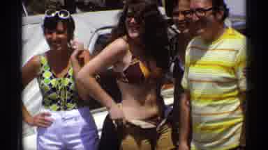 New York (1973): A Girl In Biking Is Trying To Dress Her Up Smiling