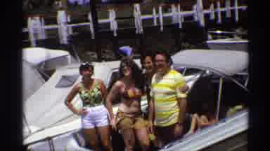 New York (1973): Girls In Bikinis Pose On Boat For Picture While Man In Yellow