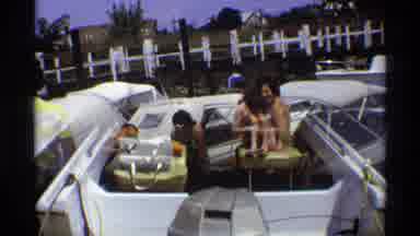 New York (1973): People Load Onto Speed Boat In Lake While Child Sits In Seat And