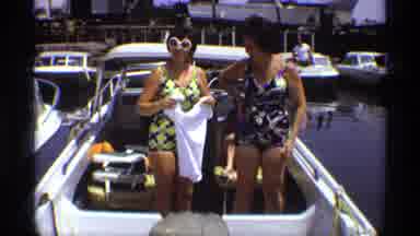 New York (1973): Woman Wearing Black And Yellow Swimsuit Holds Up White T Shirt