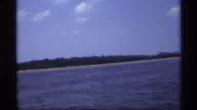 New York (1973): Person Films Speed Boat In Blue Lake On A Clear Day