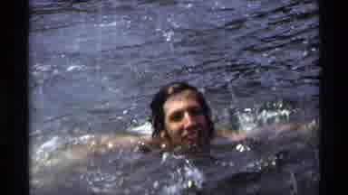 New York (1973): A Man With Long Hair Swimming And Splashing Who Then Smiles At