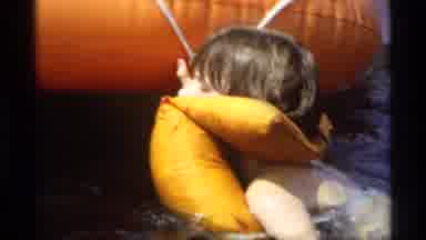 New York (1973): Child In Life Jacket Hangs On Side Of Inflatable Boat With Dad