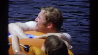 New York (1973): Adult And Child Hang Onto Life Raft With Their Hands In Body Of