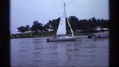 New York (1973): At The Lake The Sail Boat Sits On The Water In Front Of The Small