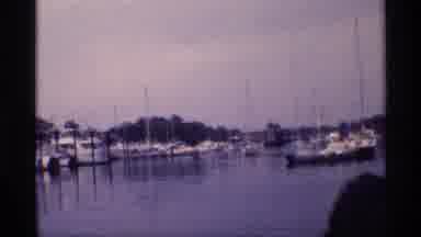 New York (1973): A Small Boat Is Entering In The Port While People Are Waiting For
