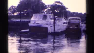 New York (1973): Several Boats Docked In A Harbor During A Sunny Day