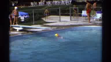 New York (1973): Little Girl Wearing A Swim Cap Is Swimming In The Pool