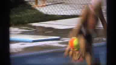 New York (1973): Person Wearing White Swim Cap Jumps Off Diving Board Into Pool On