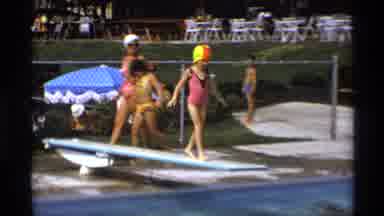 New York (1973): Child In Swimsuit And Swim Cap Jumps Off Diving Board Into Public