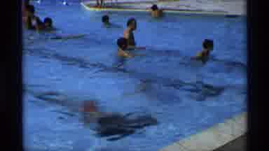 New York (1973): Boy Coming Up For Air In Busy Public Pool Shakes Hair