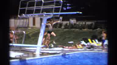 New York (1973): A Teenager Is Diving Into A Blue And Large Swimming Pool