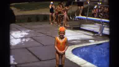 New York (1973): Young Girl Wearing A Orange Bathing Suit Standing Next To A