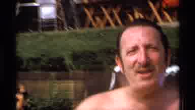 New York (1973): Man Talking To His Friend Filming On The Beach Near A Restaurant