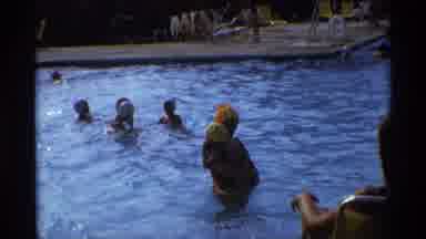 New York (1973): Family With Baby Swims At Public Pool On Sunny Day