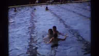 New York (1973): Happy Adult Men Practicing How To Swimming In A Big Pool