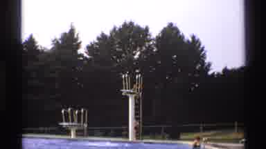 New York (1973): View Of Person Standing On Diving Board Of Swimming Pool On A