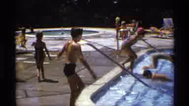 New York (1973): Boy Wearing Blue Shorts Jumps Into Crowded Swimming Pool On A
