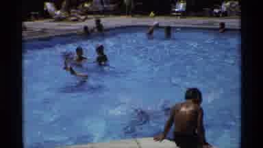 New York (1973): Person Wearing Red Cap Jumps Into Crowded Swimming Pool On A