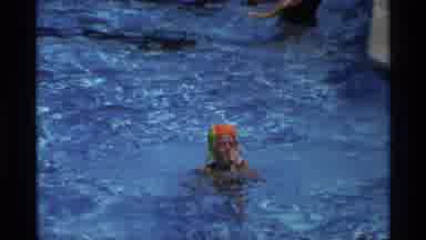 New York (1973): Girl Swimming In Pool With A Colorful Cap Holding Nose