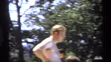 New York (1973): Man Wearing Gold Sunglasses Walks Toward Camera On A Sunny Day